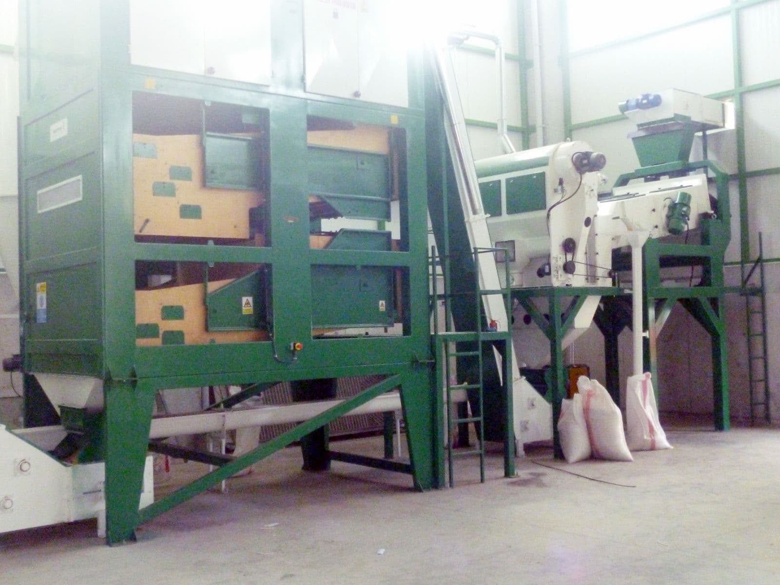 Cleaning machines in a seed processing line
